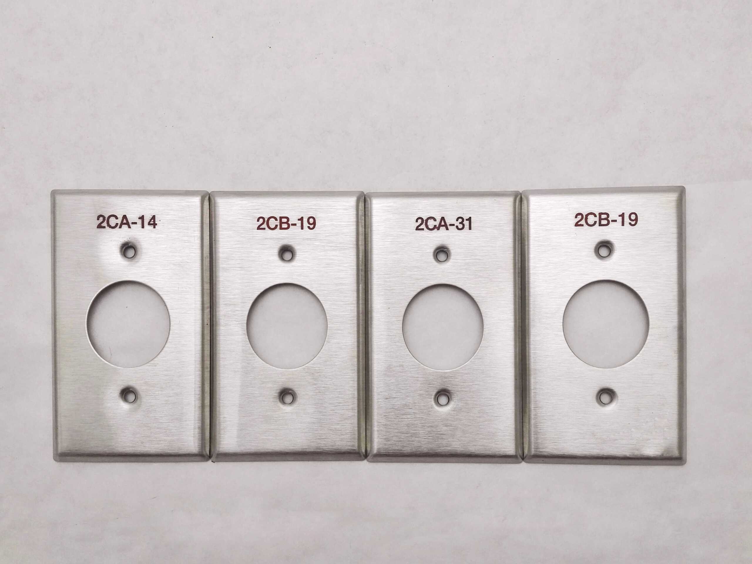 image of four custom engraved stainless steel paint-filled switch plate s with red paint-fill